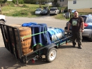 Zach from Blue Ghost Brewing Company picking up fermenters and whiskey barrels